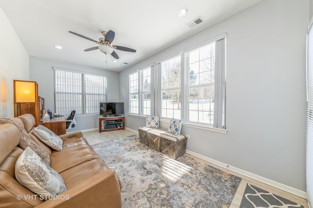 living room with ceiling fan and light wood-type flooring