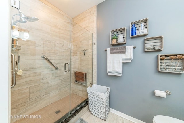 bathroom featuring toilet, hardwood / wood-style floors, and walk in shower