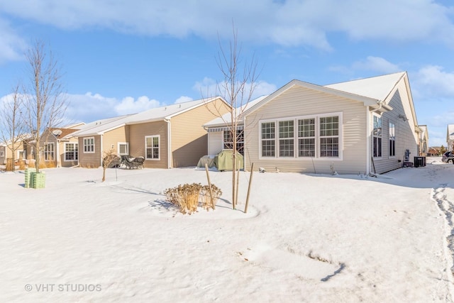 view of snow covered rear of property