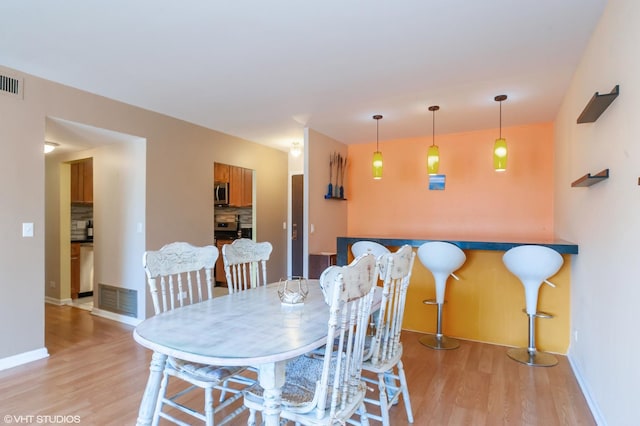 dining space featuring light hardwood / wood-style floors