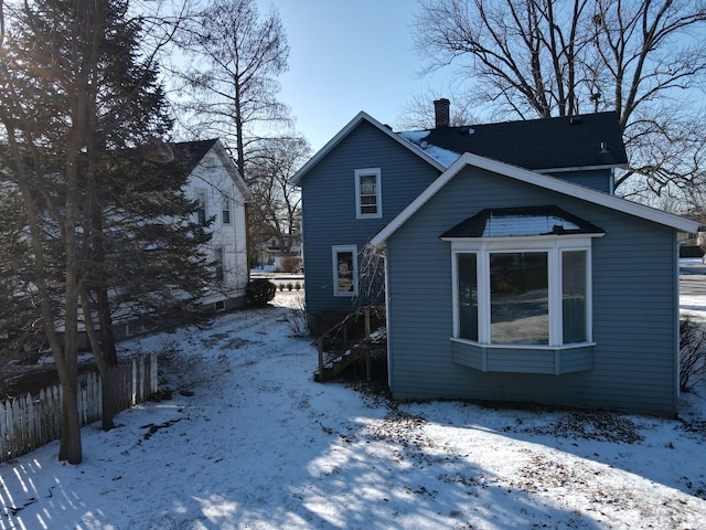 view of snow covered rear of property