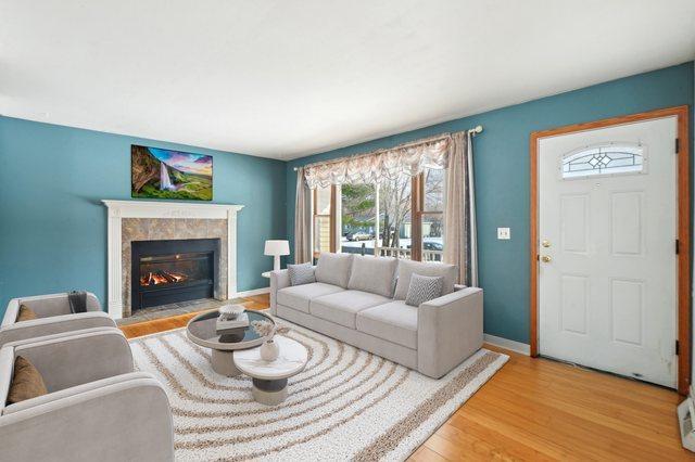 living room with light wood-type flooring and a fireplace