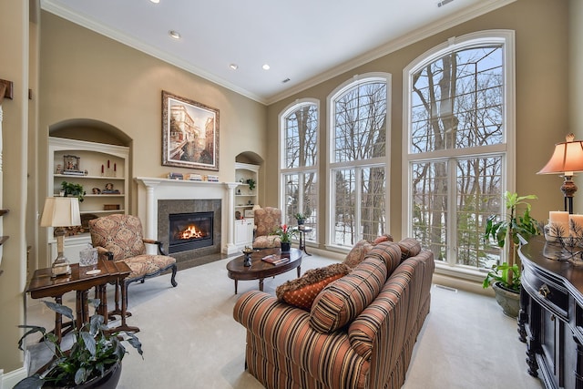 carpeted living room featuring a high ceiling, crown molding, and built in features