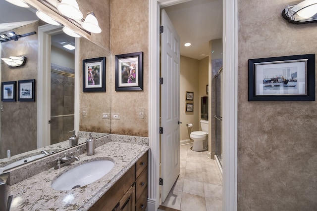 bathroom featuring vanity, toilet, an enclosed shower, and tile patterned flooring