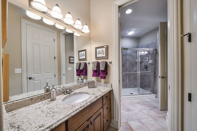 bathroom with walk in shower, tile patterned floors, and vanity