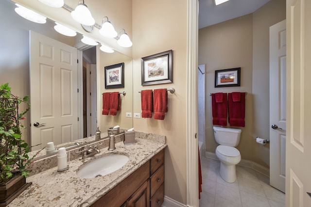 bathroom featuring vanity, a shower, tile patterned floors, and toilet