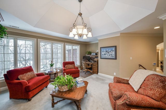 carpeted living room featuring an inviting chandelier, ornamental molding, a raised ceiling, and a wealth of natural light