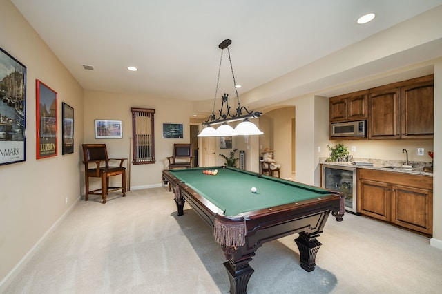 rec room featuring wine cooler, pool table, light colored carpet, and indoor wet bar