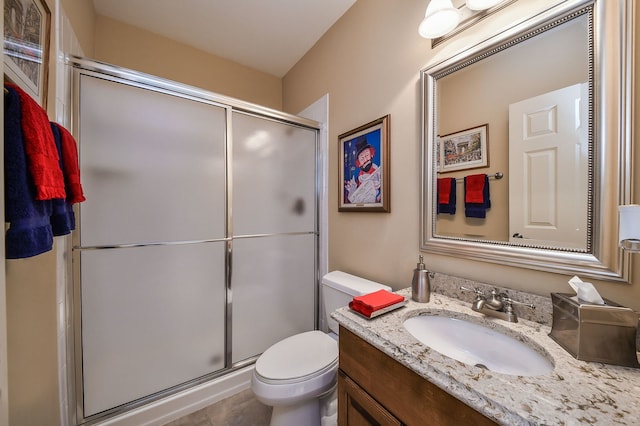 bathroom with walk in shower, vanity, and toilet