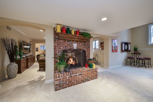 carpeted living room featuring a fireplace and ornamental molding