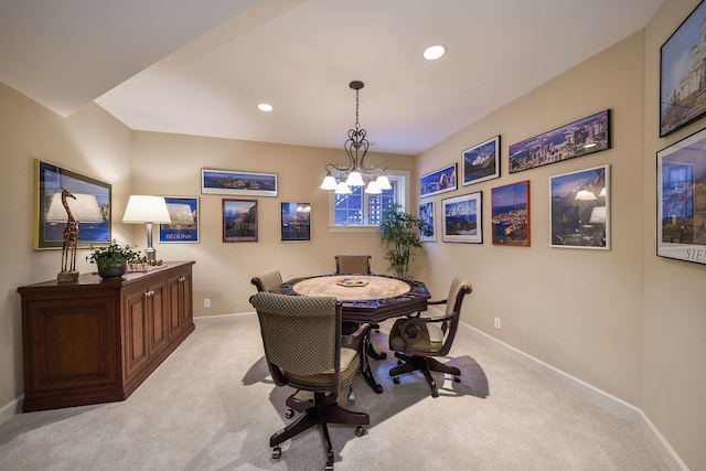 dining area featuring light colored carpet and a chandelier