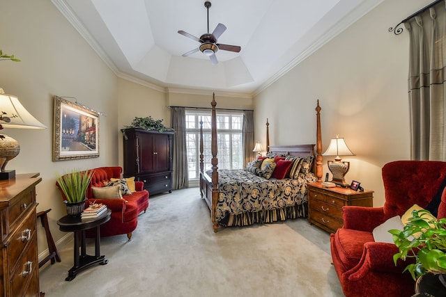 carpeted bedroom with a raised ceiling, ornamental molding, and ceiling fan