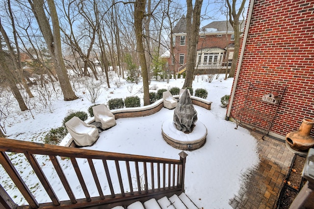 snow covered deck with a fire pit