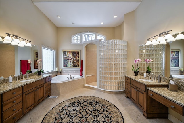 bathroom featuring tile patterned floors, vanity, and separate shower and tub