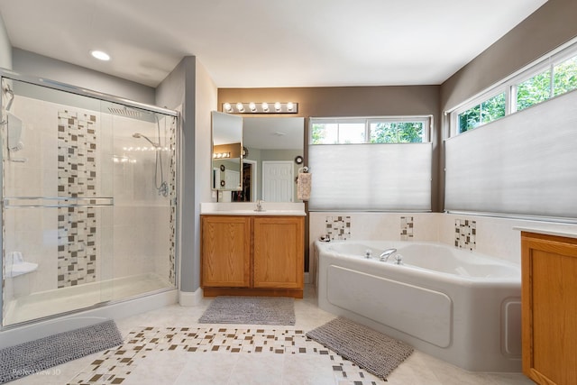 bathroom with plus walk in shower, vanity, and tile patterned floors