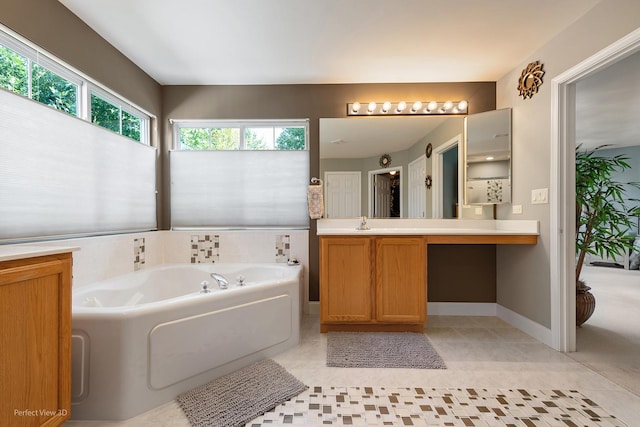 bathroom featuring vanity, tile patterned floors, and a tub