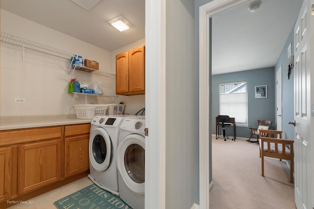 laundry area with cabinets, light colored carpet, and washing machine and dryer