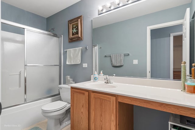 full bathroom with tile patterned floors, toilet, vanity, and combined bath / shower with glass door