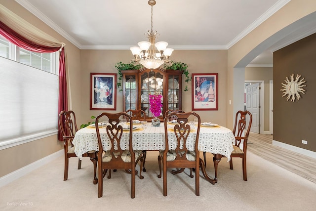 dining room featuring light carpet, crown molding, plenty of natural light, and a notable chandelier