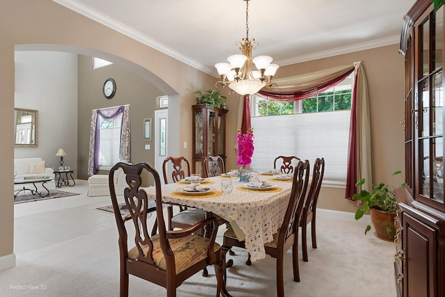 carpeted dining area featuring crown molding and an inviting chandelier