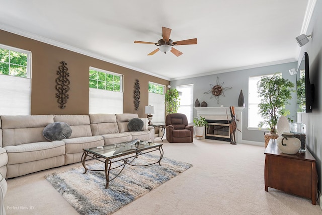 living room featuring carpet flooring, a healthy amount of sunlight, ceiling fan, and crown molding