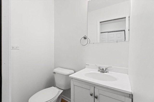 bathroom with toilet and vanity