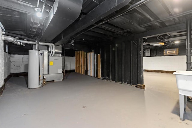 basement featuring heating unit and gas water heater