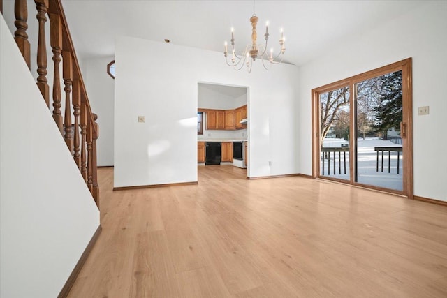 unfurnished dining area featuring light hardwood / wood-style flooring and an inviting chandelier