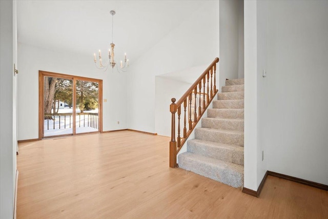 foyer entrance featuring hardwood / wood-style flooring and a notable chandelier