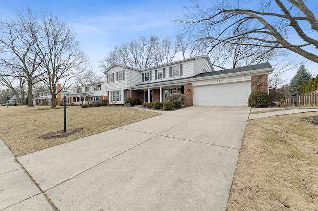 view of property featuring a garage and a front yard