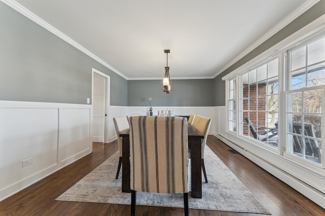 dining space with crown molding, dark hardwood / wood-style floors, and baseboard heating