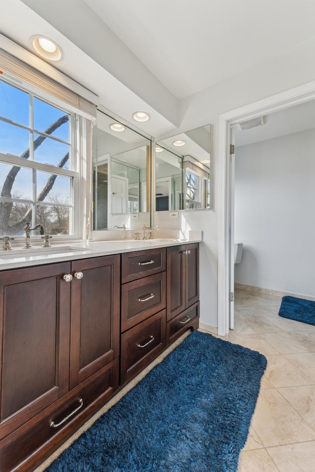 bathroom featuring tile patterned flooring and vanity