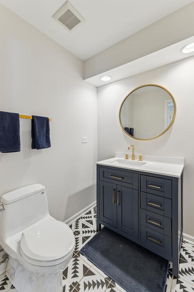 bathroom featuring vanity and toilet