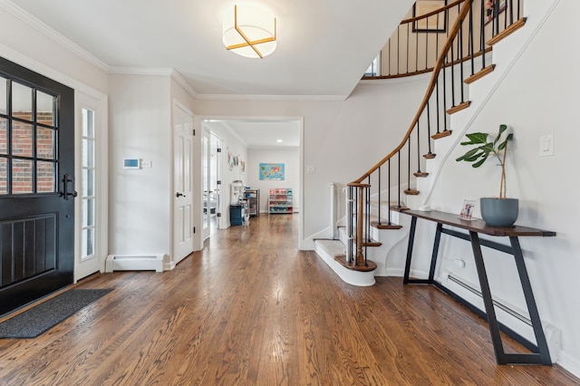 entryway with baseboard heating, dark hardwood / wood-style flooring, and crown molding