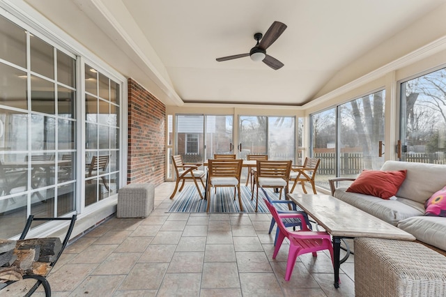 sunroom with lofted ceiling, a healthy amount of sunlight, and ceiling fan