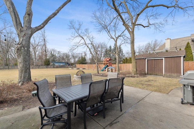 view of patio with a playground, a grill, and a storage unit