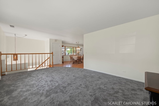 empty room with carpet and a chandelier