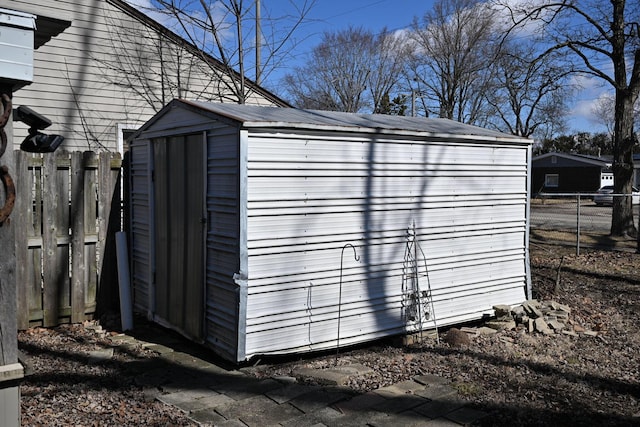 view of shed featuring fence