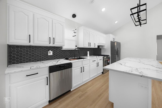 kitchen featuring white cabinets, pendant lighting, stainless steel appliances, and sink