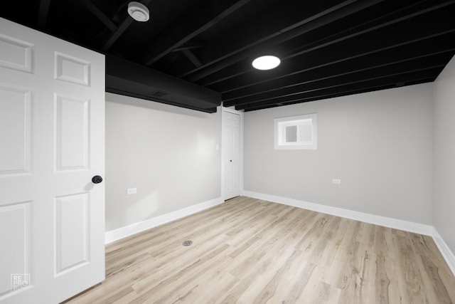 basement with light hardwood / wood-style floors