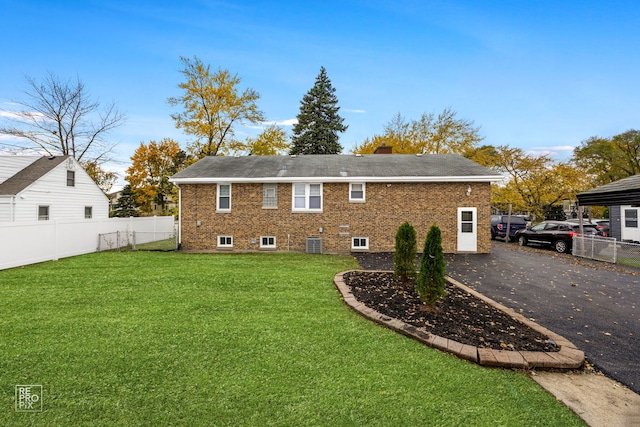 back of property with a yard and cooling unit