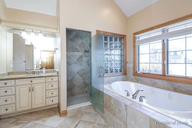 bathroom with vanity, lofted ceiling, and plus walk in shower