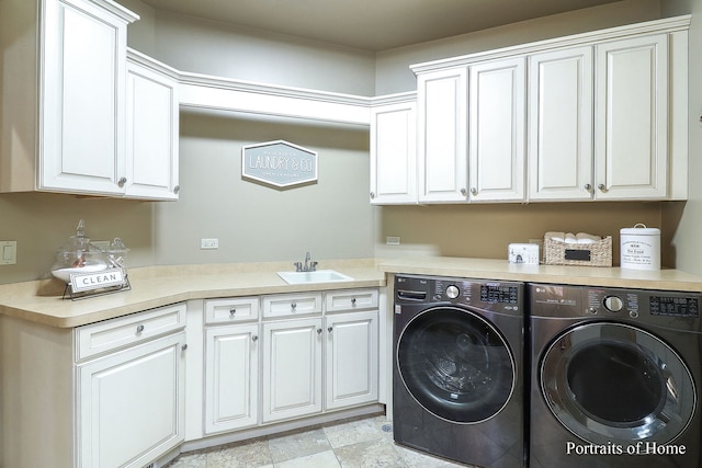 laundry room featuring cabinets, washer and clothes dryer, and sink