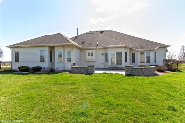 rear view of property with a yard and a patio