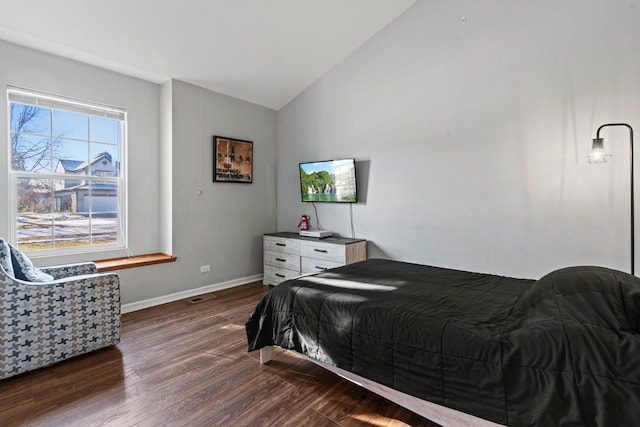 bedroom with dark hardwood / wood-style flooring and lofted ceiling