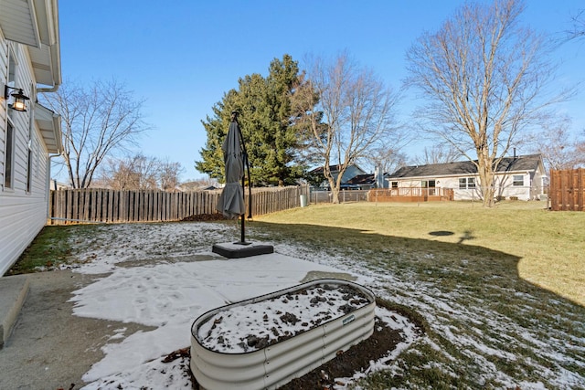 yard covered in snow with a patio