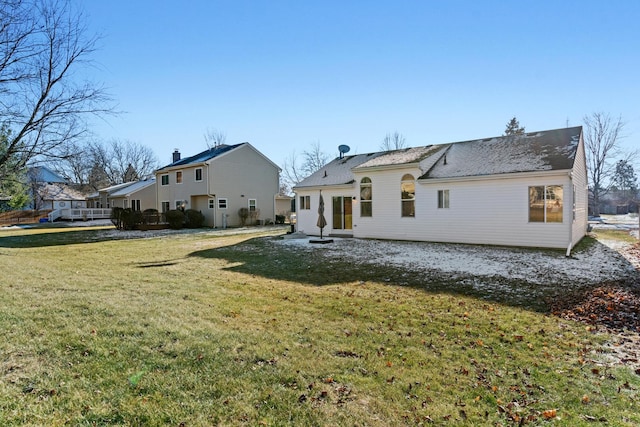 back of house with a lawn