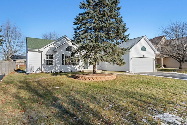 view of front facade with a front yard and a garage