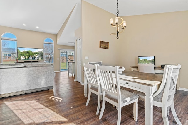 dining area with dark wood-type flooring and a notable chandelier