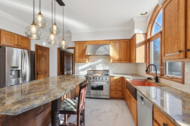 kitchen featuring light stone countertops, appliances with stainless steel finishes, wall chimney exhaust hood, tasteful backsplash, and sink